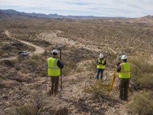 Surveying companies in Bullhead City AZ working across a large rocky desert site with difficult access and rugged terrain.